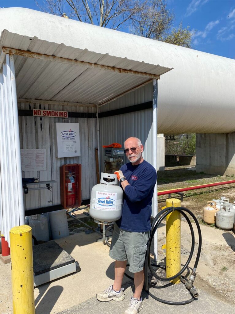 man with 20lb propane tank