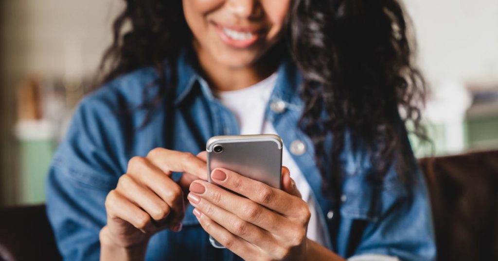 woman smiling at phone
