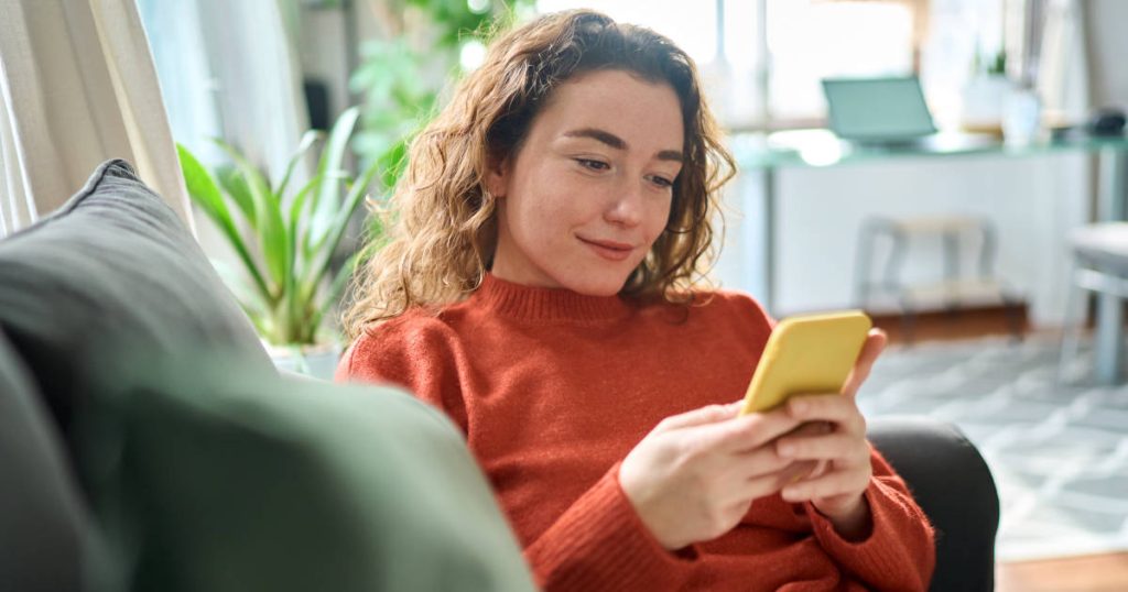 woman smiling at smart phone